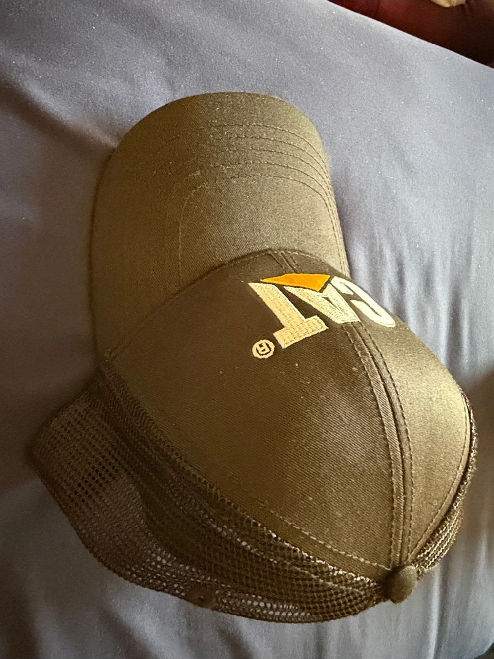 Caterpillar Black Trucker Hat with Yellow Logo